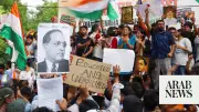 Cockroach Janta Party supporters bang plates demanding India education minister's resignation