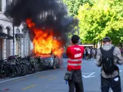 Geneva Police Fire Teargas at G7 Protesters Who Set Tesla on Fire